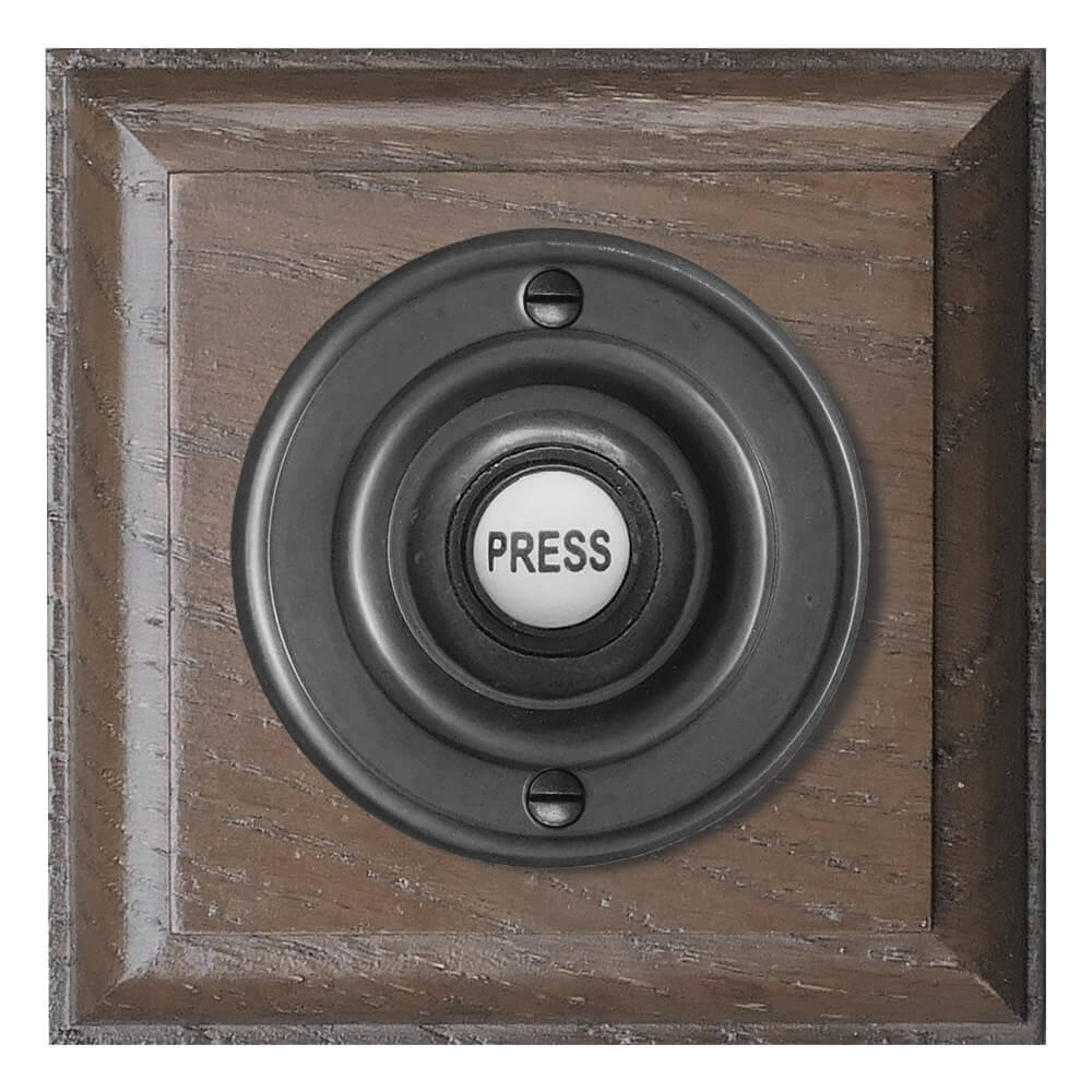 Black wired Door bell push button on a Tudor Oak Plinth, 100mm square