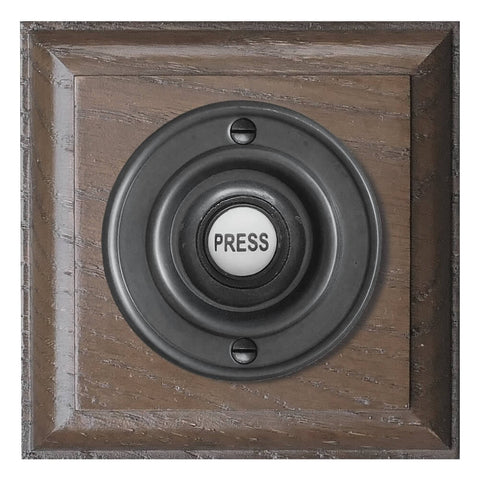 Black wired Door bell push button on a Tudor Oak Plinth, 100mm square plinth , 63mm diameter